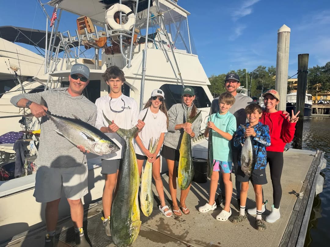 Successful fishing charter in Charleston SC displaying caught blackfin tuna and mahi mahi on dock