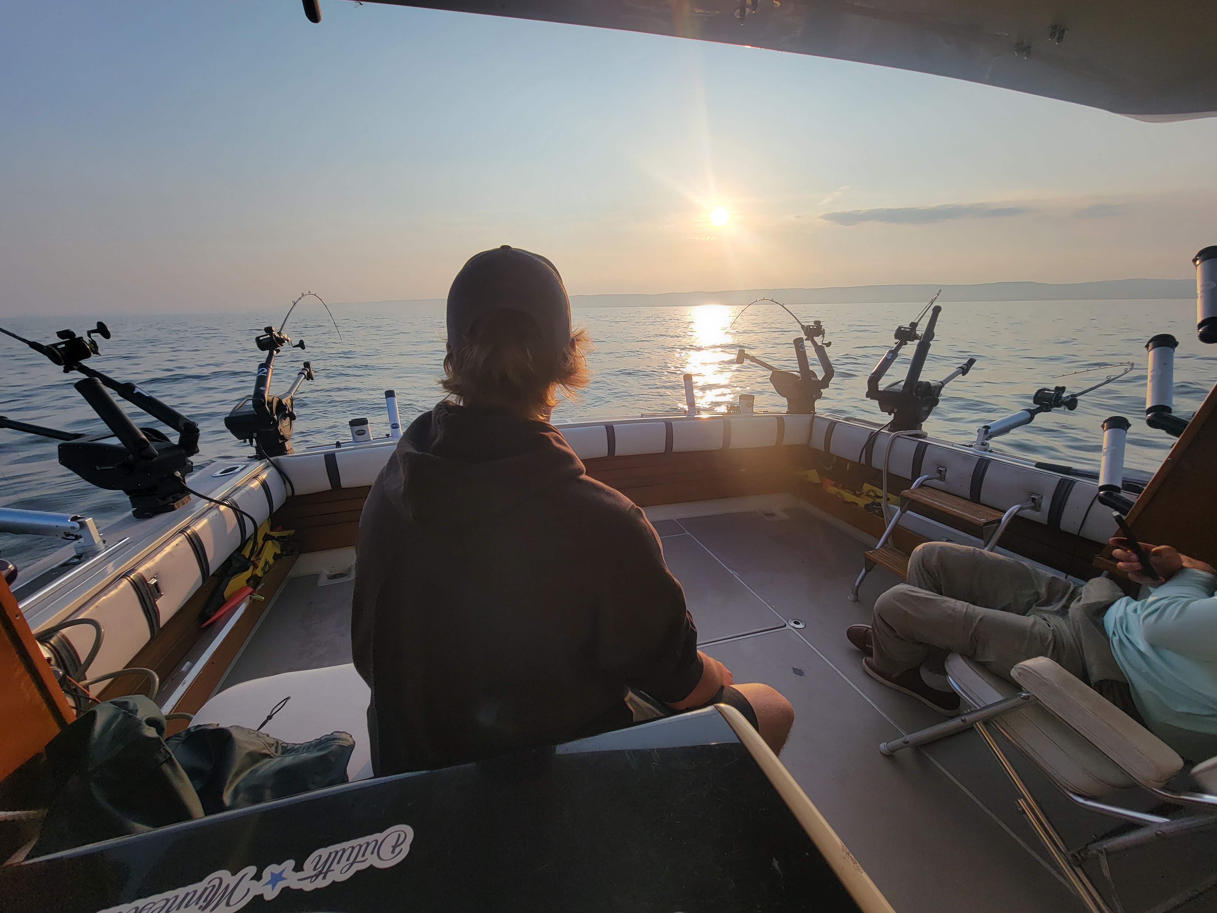 Lake Superior fishing charter boat with anglers catching trout and salmon on morning trip