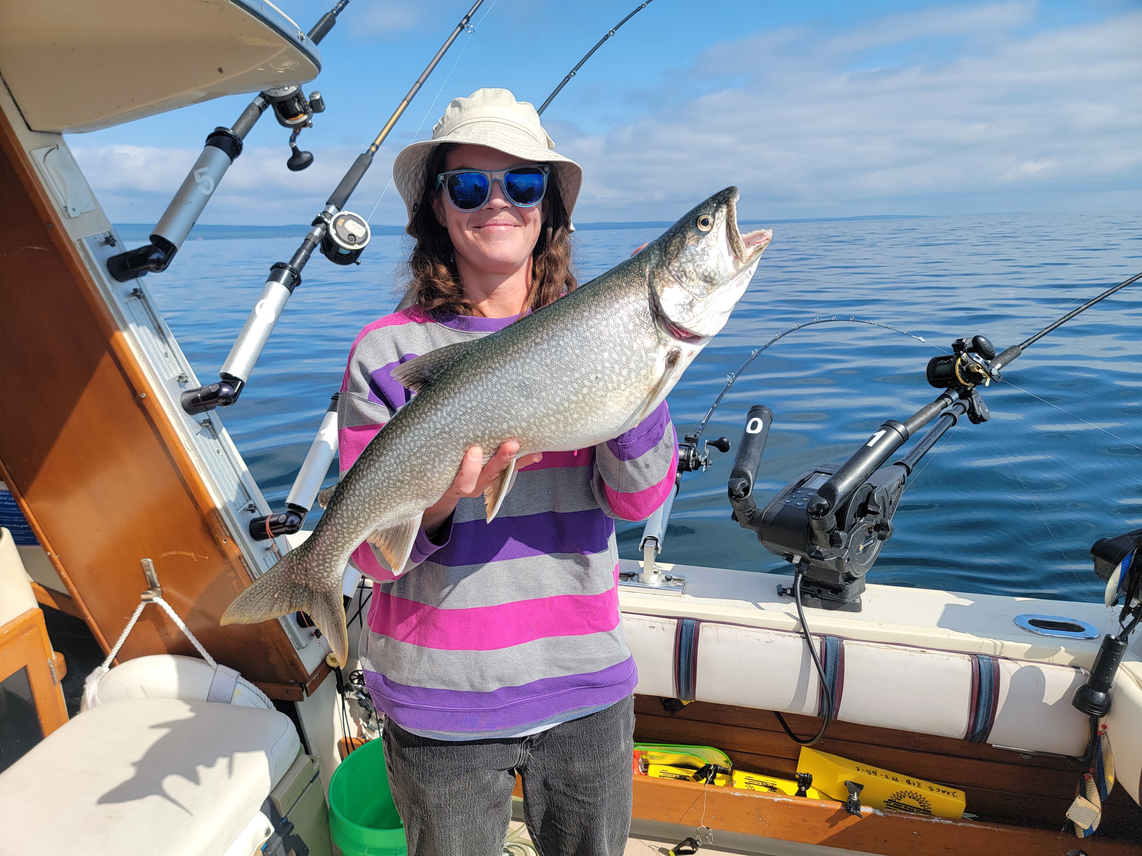 Lake Superior fishing charter boat with anglers targeting trout and salmon on morning trip