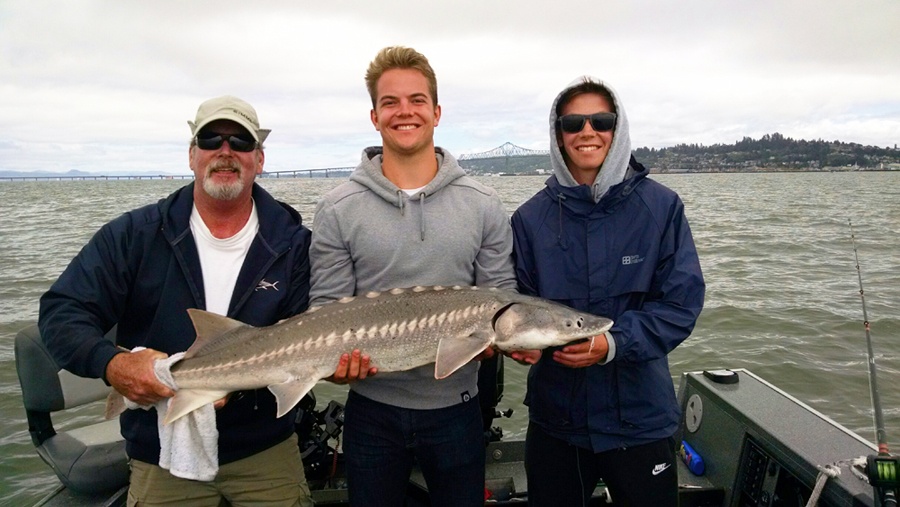Fisherman with a white sturgeon in Oregon