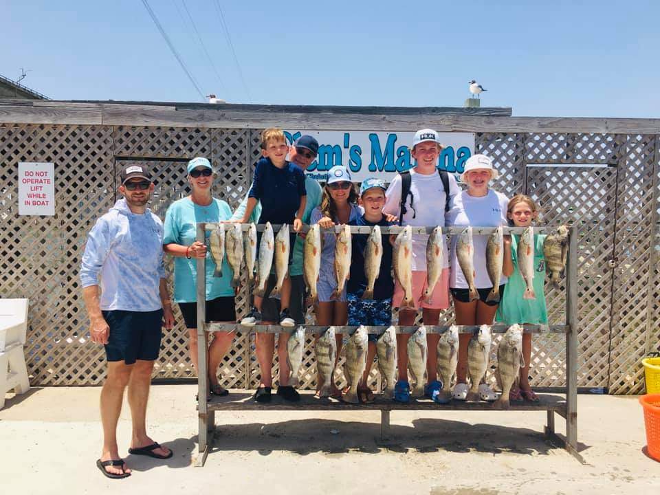 A group of 9 people enjoying a fishing trip in Corpus Christi