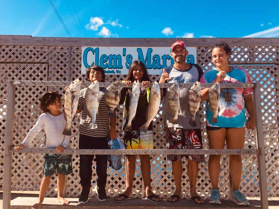4 anglers with a successful fishing catch in TX