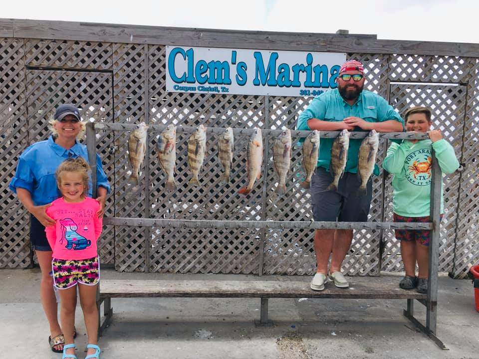 4 people fishing on the water in TX