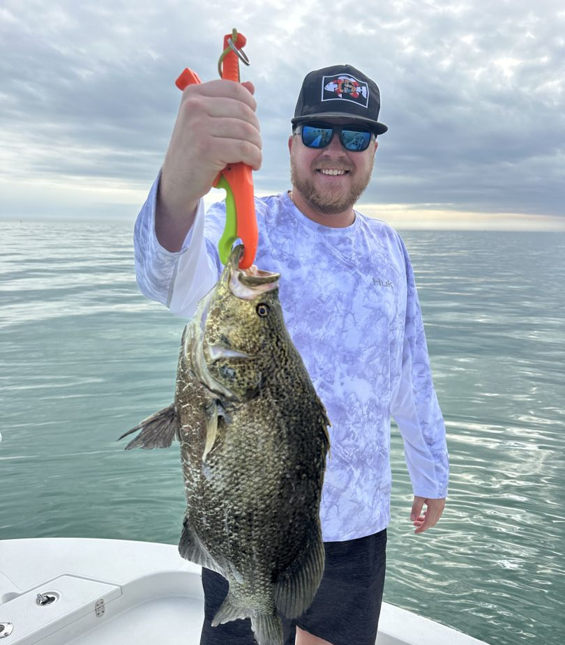 Angler holding a 21-inch fish in Indian Shores