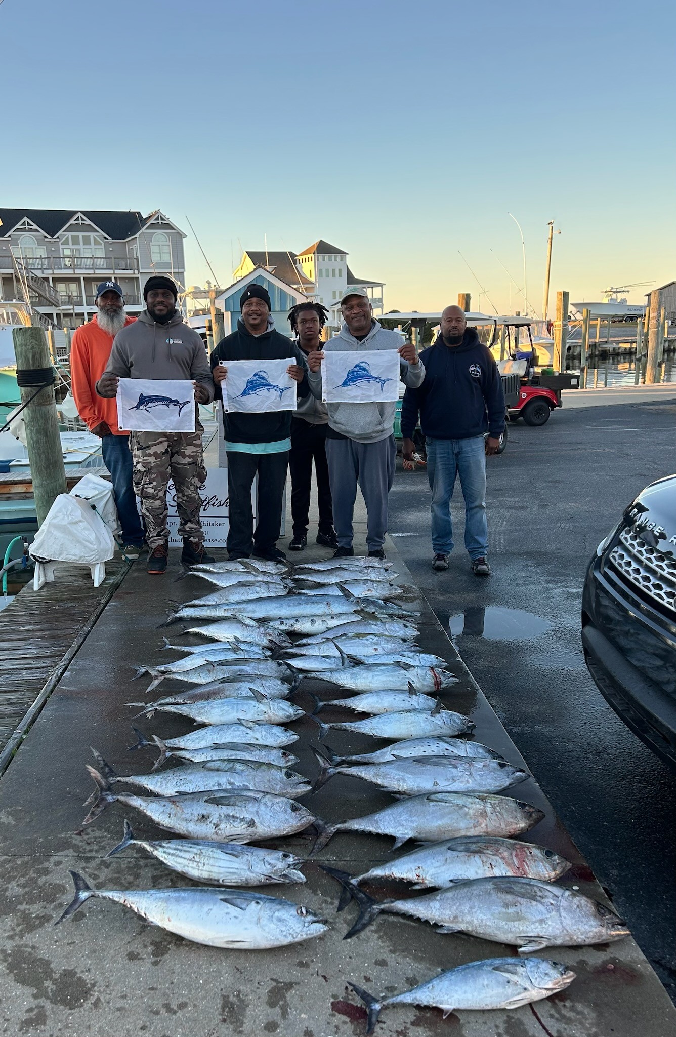 Successful fishing trip in Hatteras NC with large catch of Little Tunny, Blackfin Tuna, and Bluefin Tuna displayed on dock