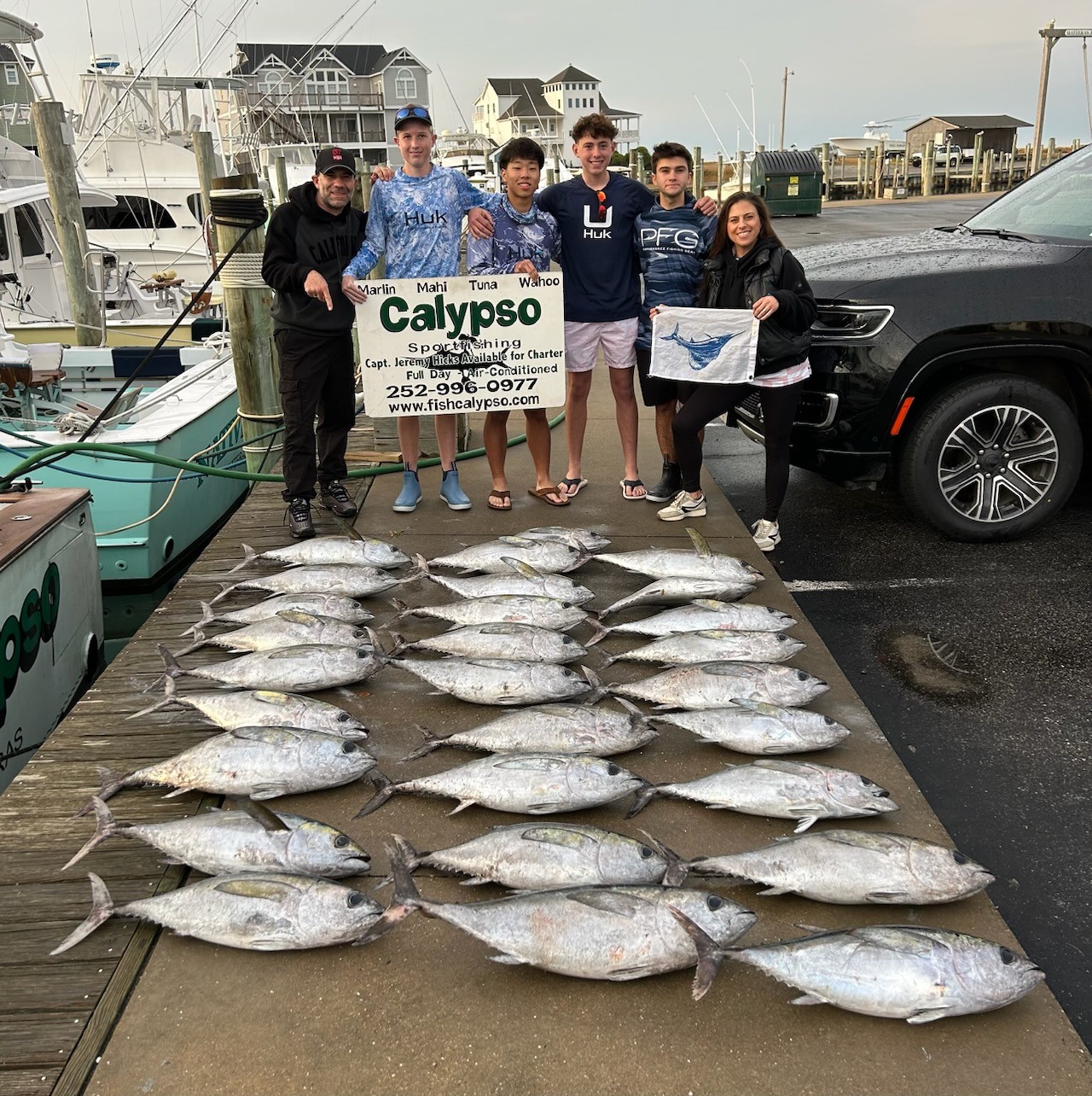 Large catch of blackfin and yellowfin tuna displayed on fishing dock in Hatteras NC