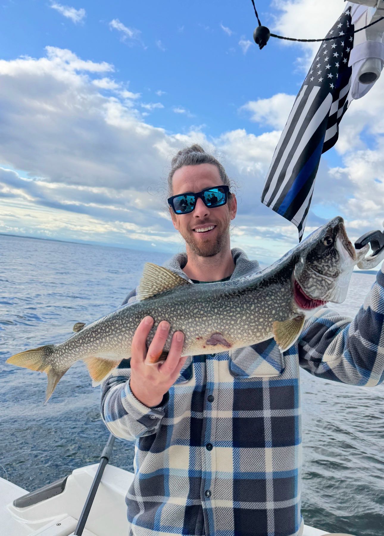 Lake trout catch on fishing boat in Cumberland Head NY with American flag