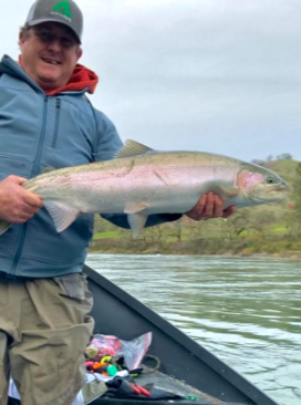 Fisherman holding a 23-inch fish in OR
