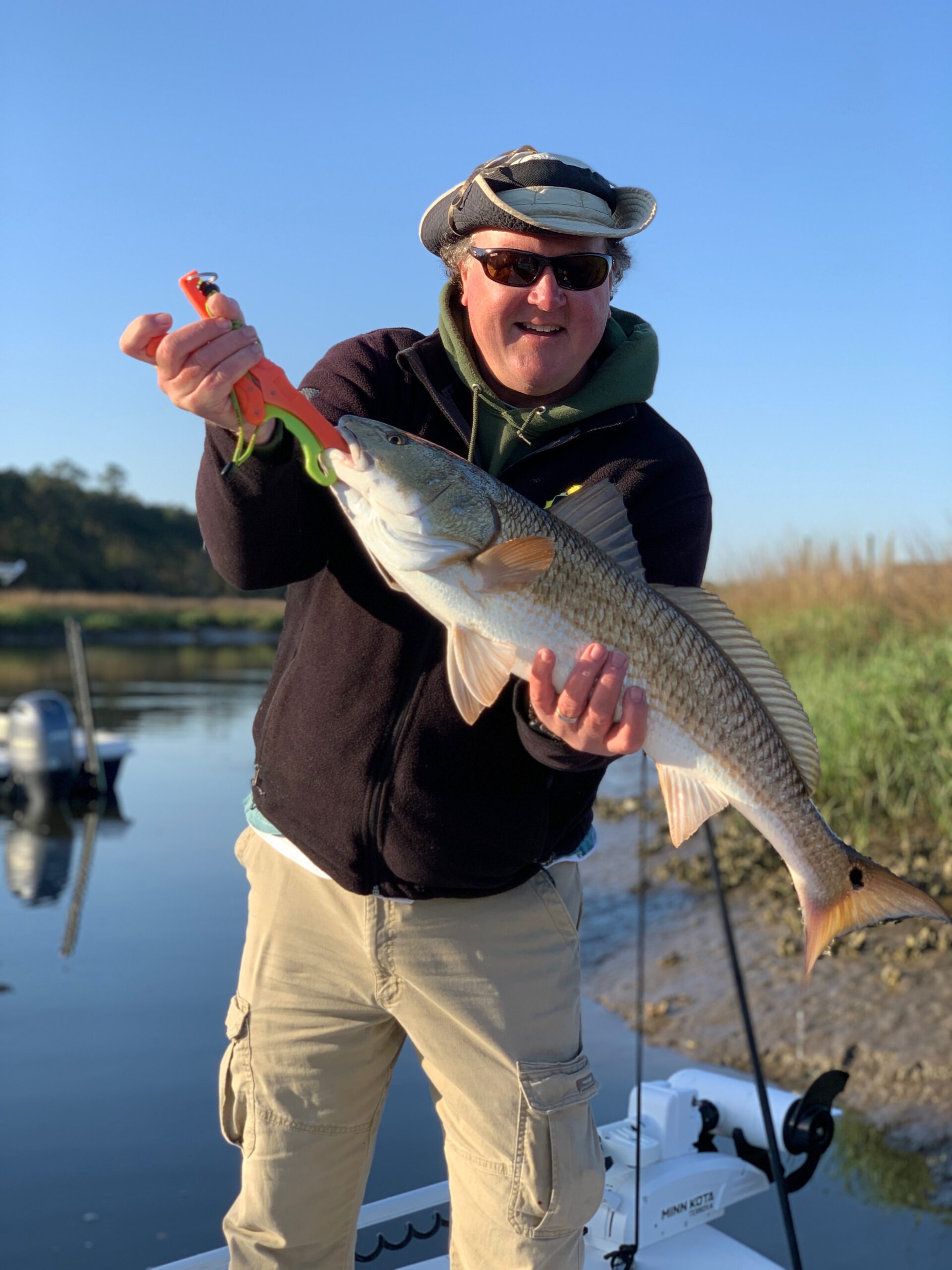 A fisherman holding a large redfish on Johns Island