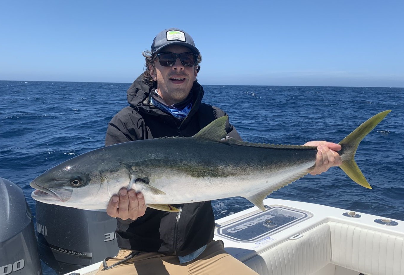 A fisherman holds a 29-inch catch in CA