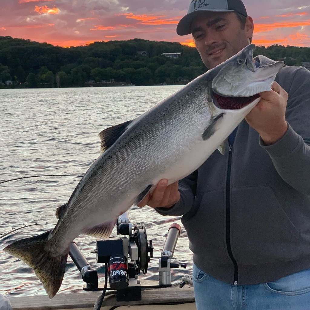 Fisherman holding a 23-inch catch in MI