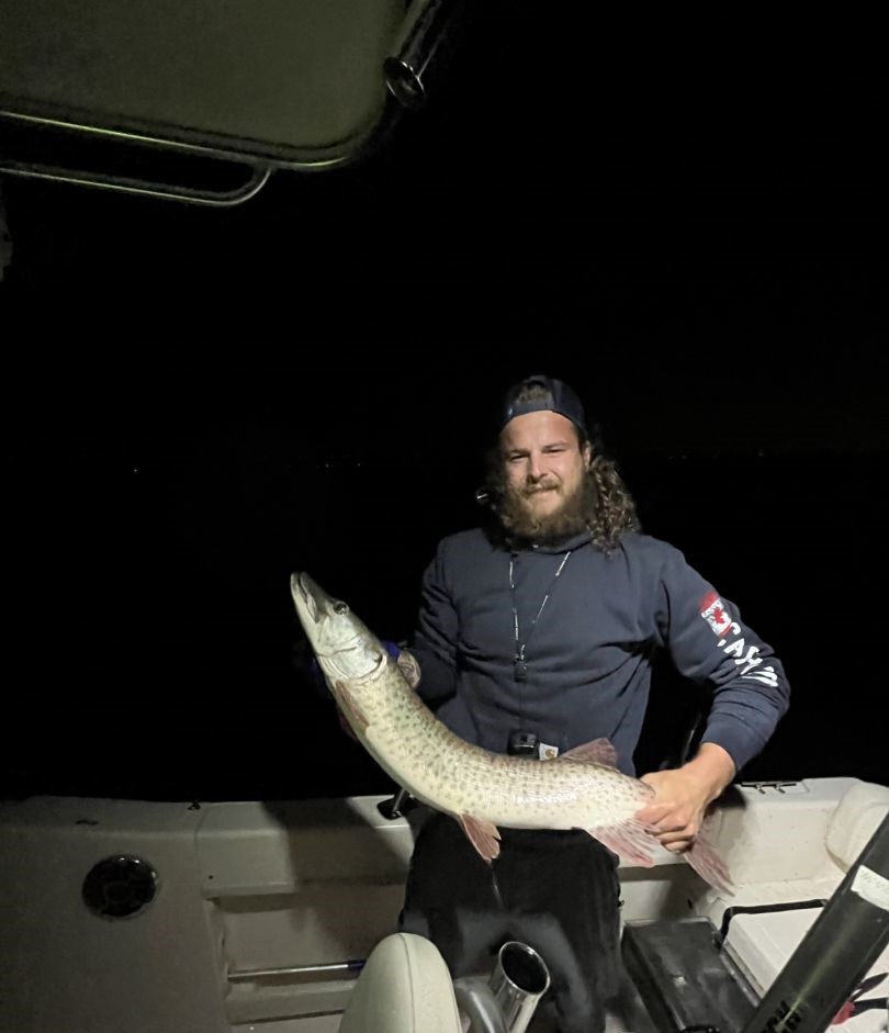 A fisherman holding a large muskellunge in Ontario