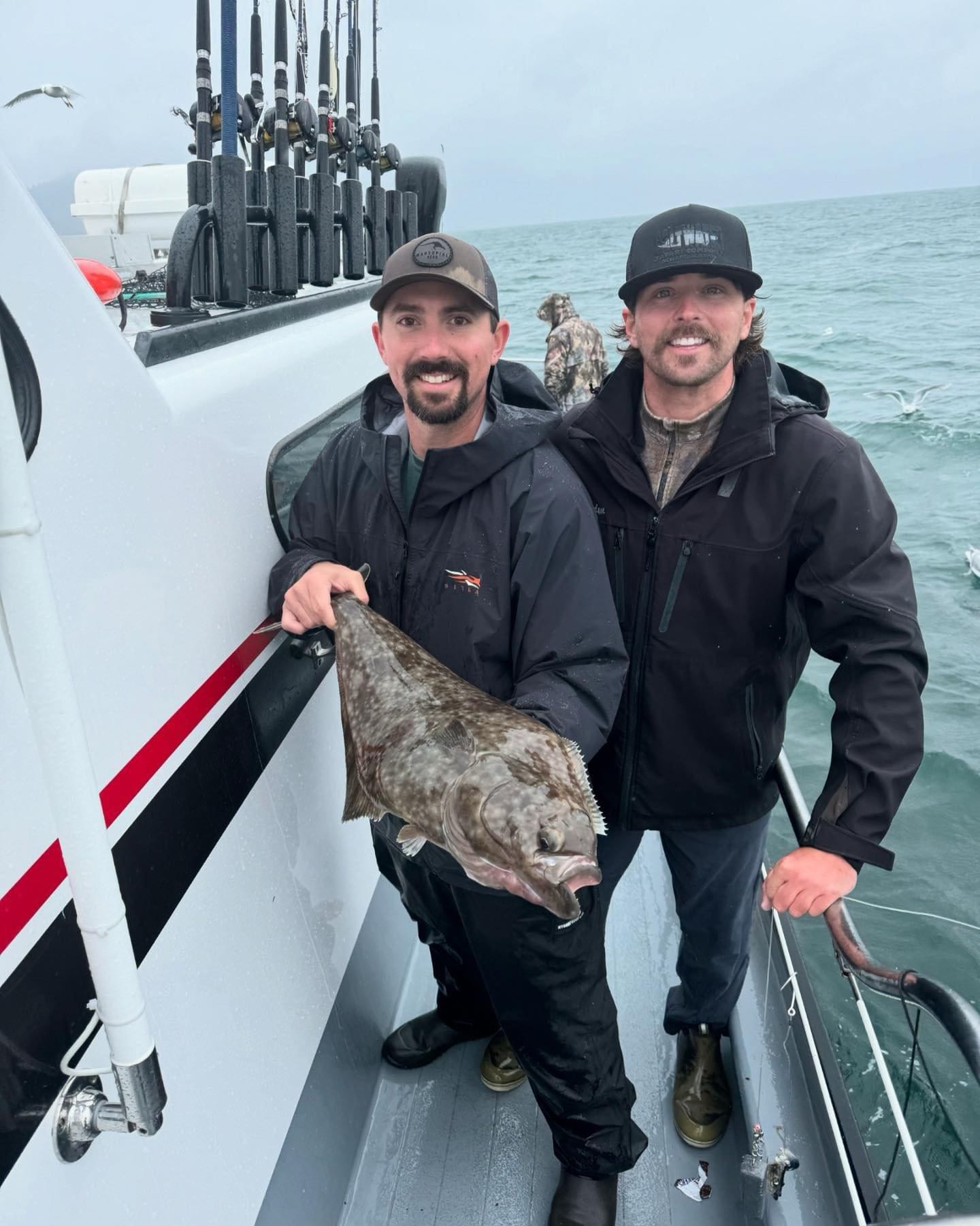 A large Pacific Halibut caught by two people fishing in Alaska