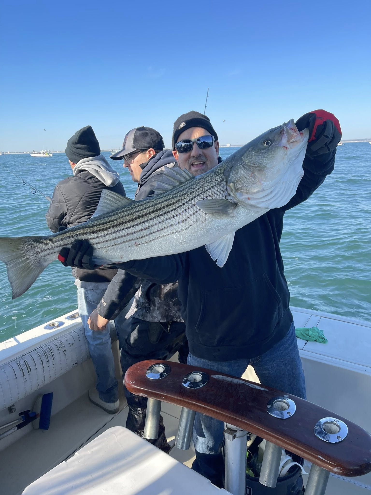 Striped bass fishing boat departing Keyport NJ harbor for guided afternoon inshore trip
