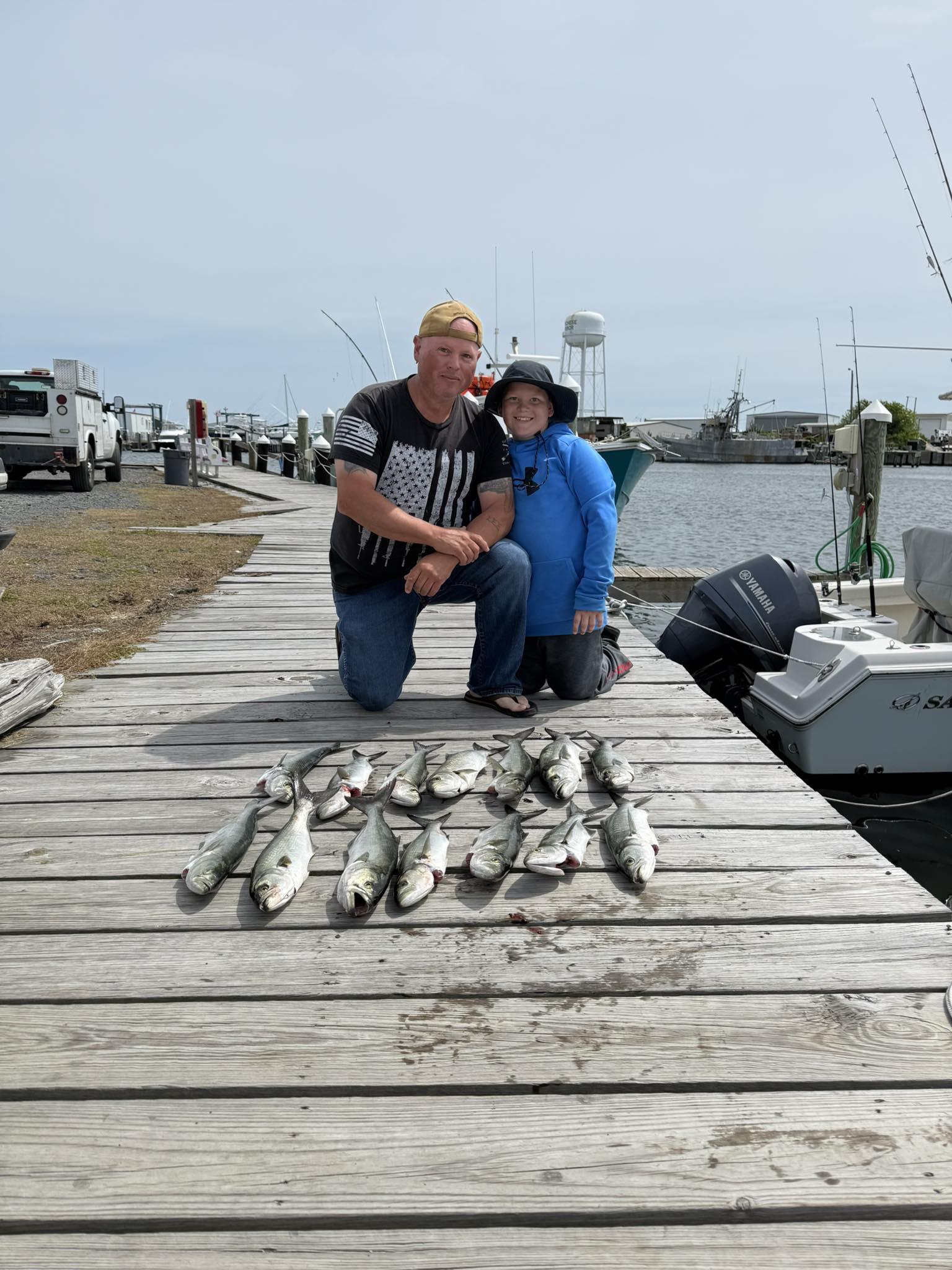Successful bluefish fishing trip on wooden dock in Wanchese NC with fresh catch displayed