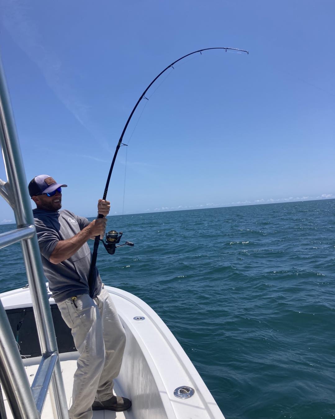 Fishing rod bent with catch on boat in Wanchese NC waters