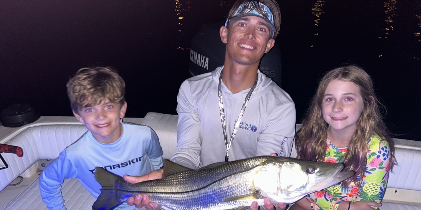 Three anglers with a large 26-inch fish caught in Sarasota