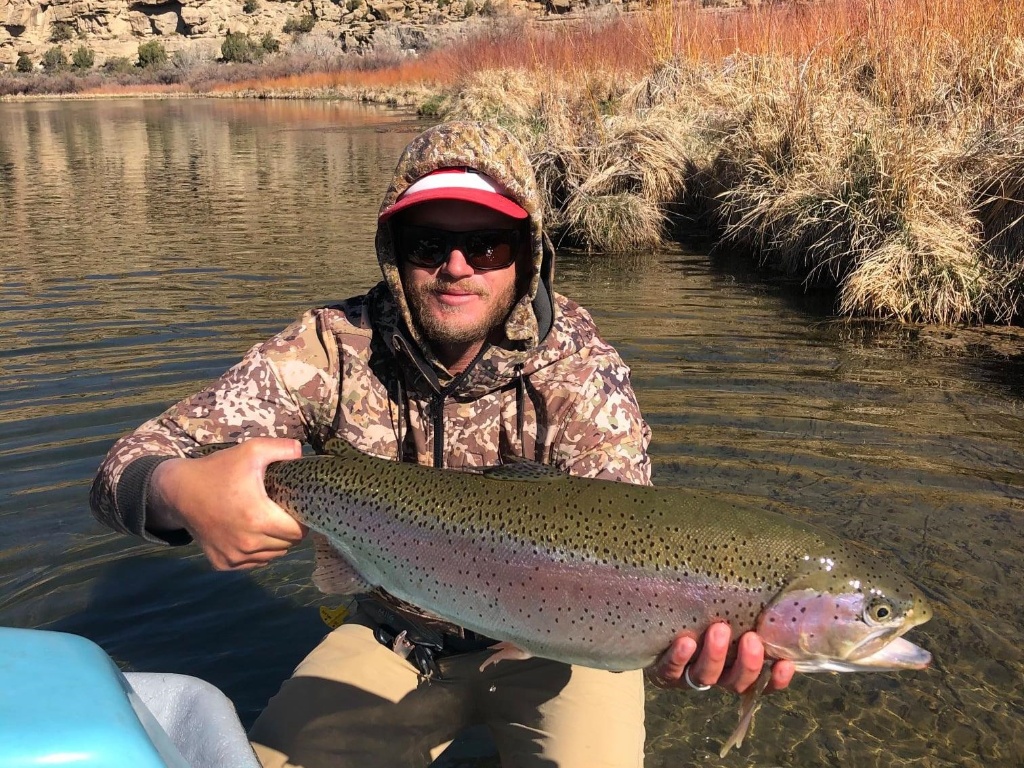 Fisherman with a 23-inch rainbow trout in Farmington