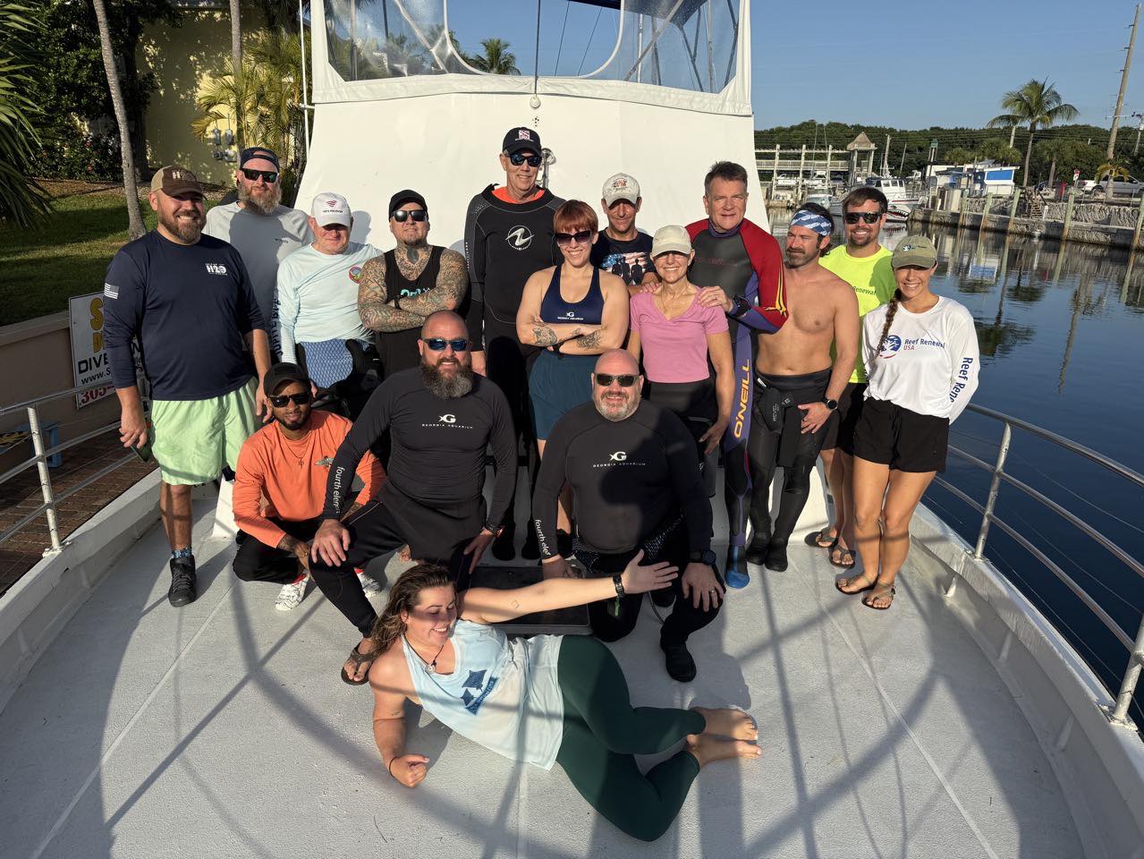 Large group gathered on dive boat deck at marina in Key Largo FL