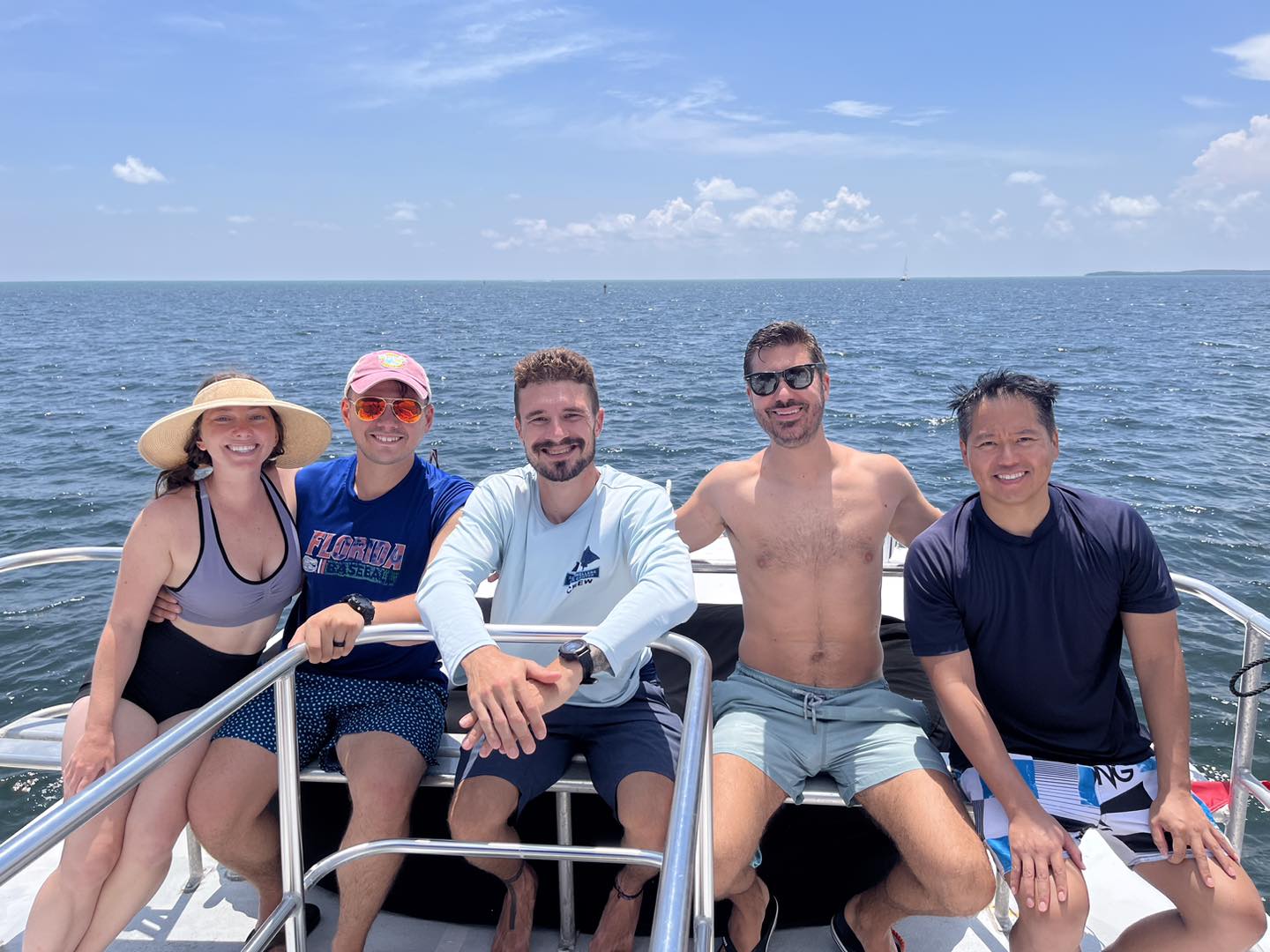 Group enjoying a day of water sports on a boat in open ocean waters