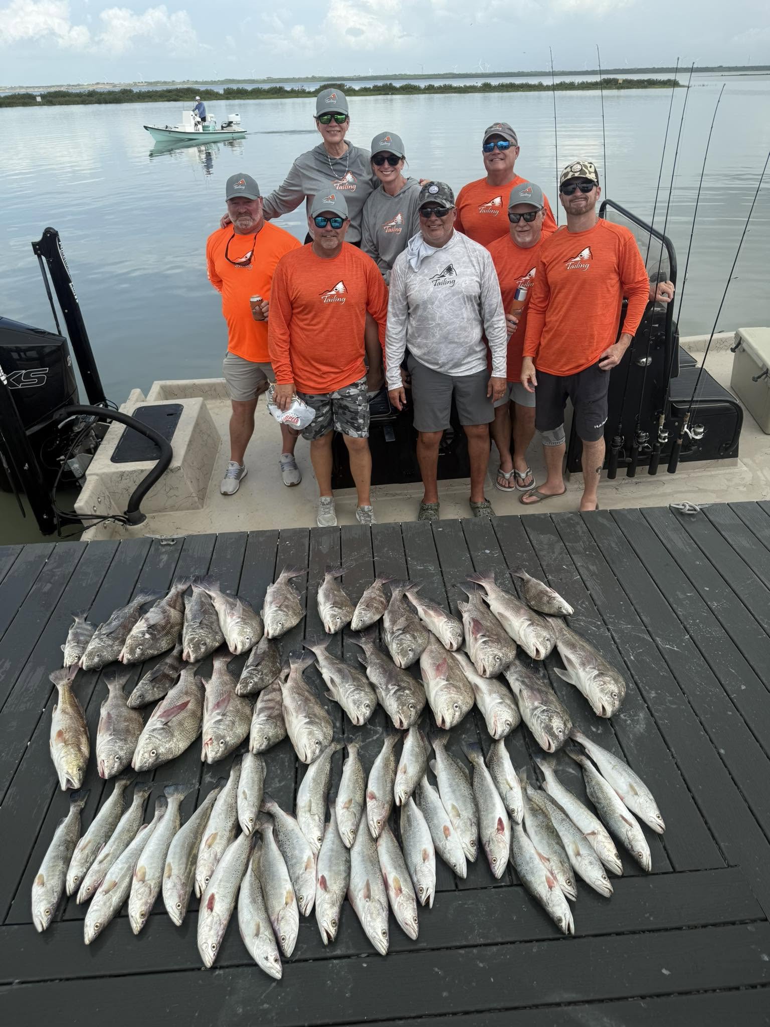 Large catch of fish displayed on wooden dock after successful fishing trip in Corpus Christi TX