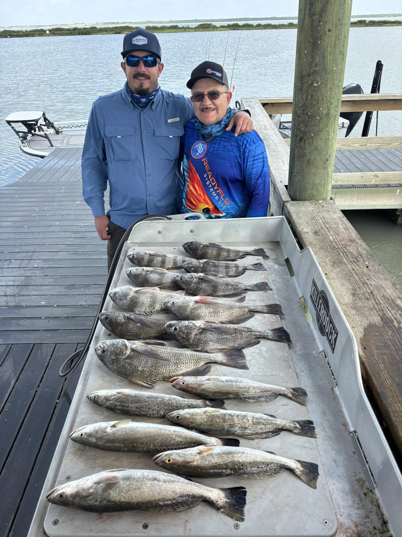 Successful fishing trip in Corpus Christi TX showing speckled trout and black drum catch on dock