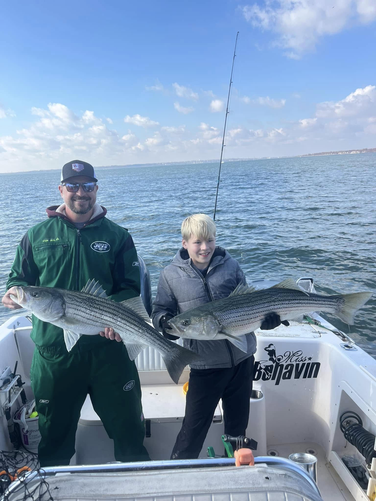 Two striped bass caught fishing in Woodbridge Township NJ displayed on boat