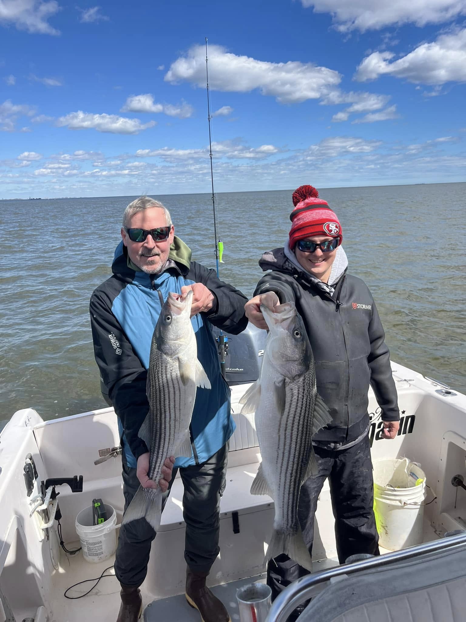 Striped bass fishing charter boat in Raritan Bay, Woodbridge NJ with anglers and gear