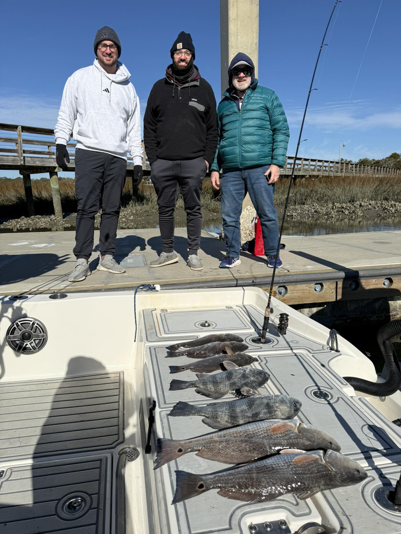 Successful fishing trip in Mount Pleasant SC showing redfish and black drum catch on boat deck