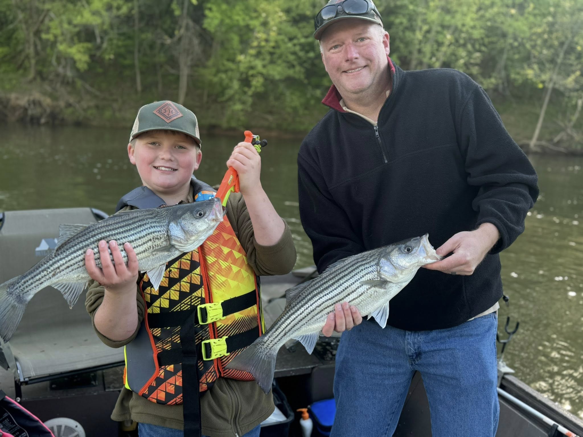 Two striped bass caught fishing in Weldon NC displayed on boat