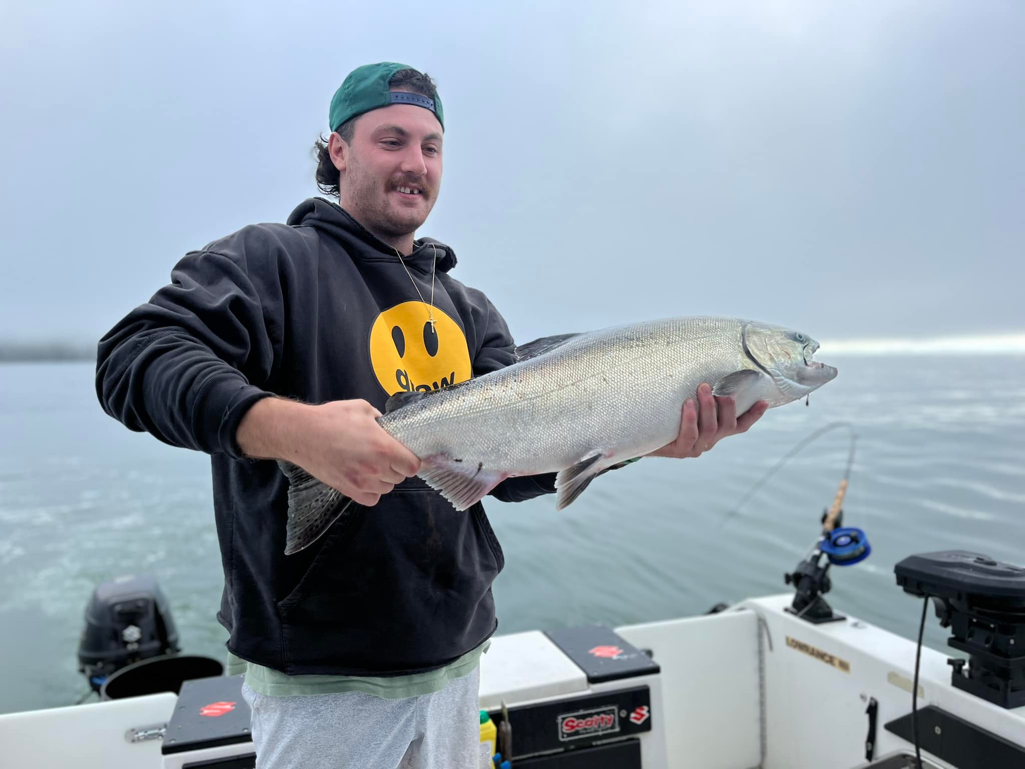A person fishing for a lake trout in Port Alberni