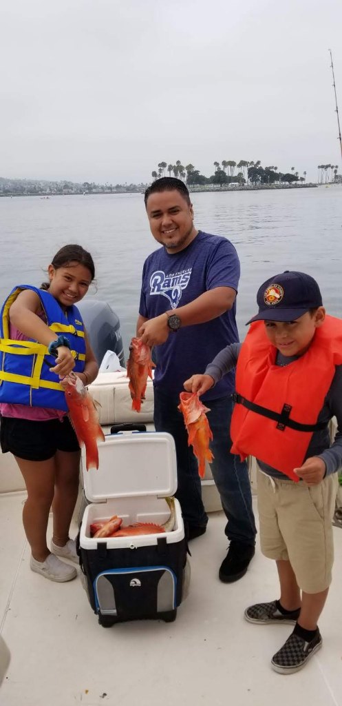 Three people enjoying a fishing trip in San Diego