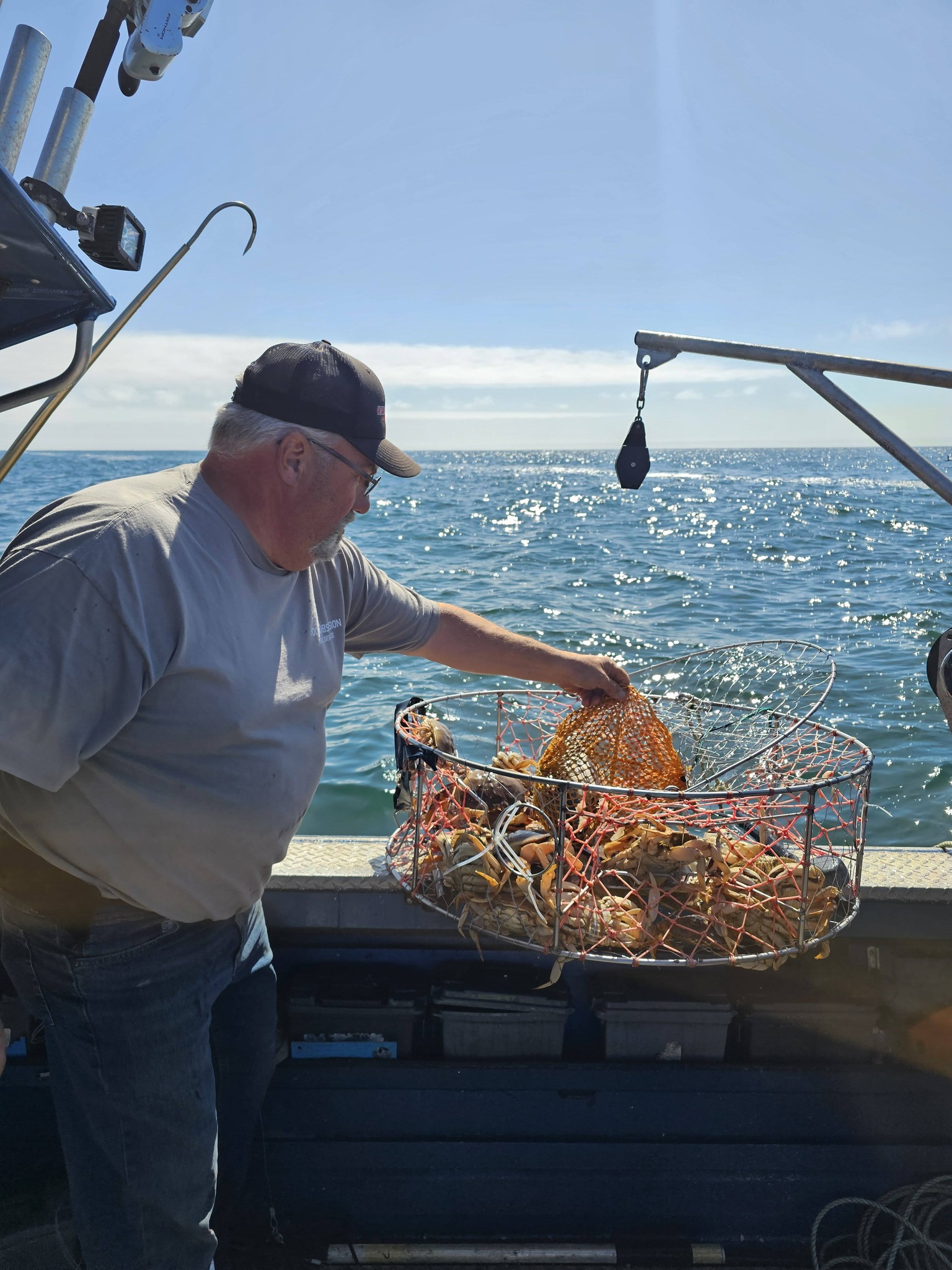 Crab trap being handled on fishing boat deck in Reedsport OR waters