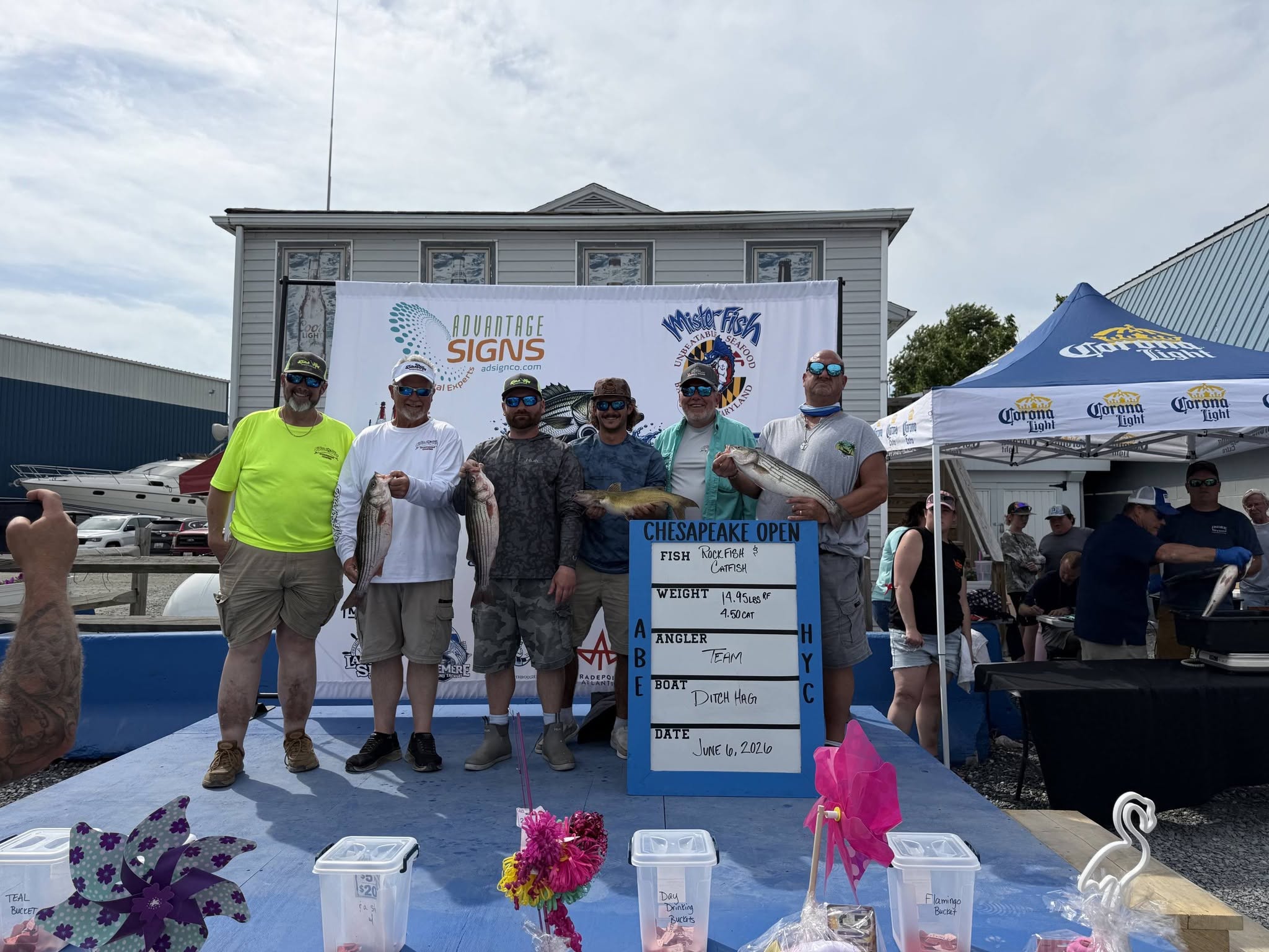 Fishing tournament winners displaying striped bass and channel catfish catch in Baltimore MD