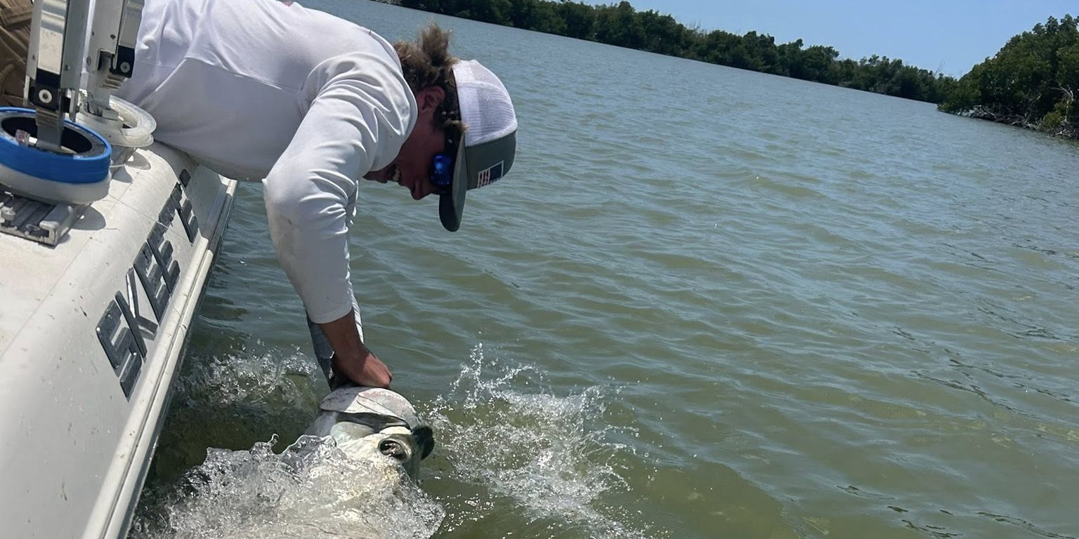 Beginner tarpon fishing guide with two anglers in calm waters near 10000 Islands Florida