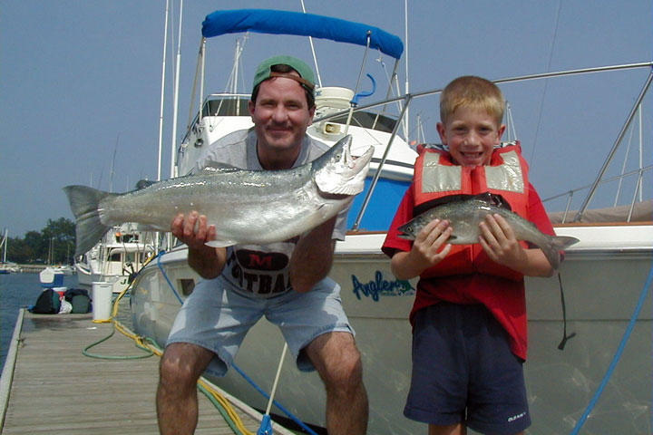 Two people fishing in Illinois with two big fish
