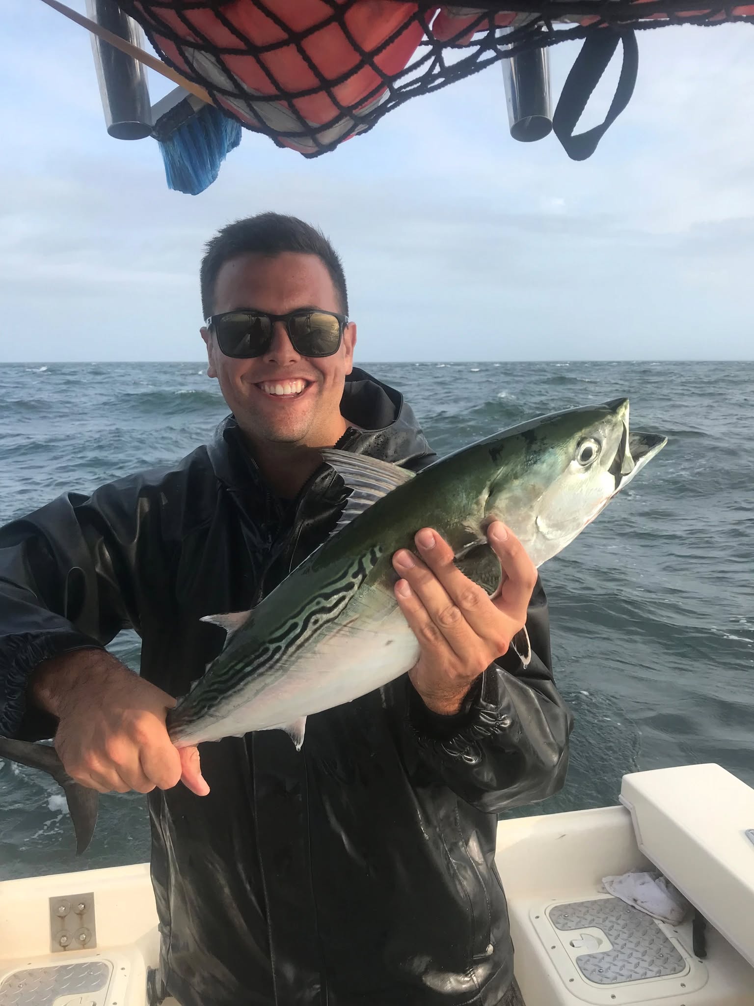 Angler holding a little tunny fish in New London
