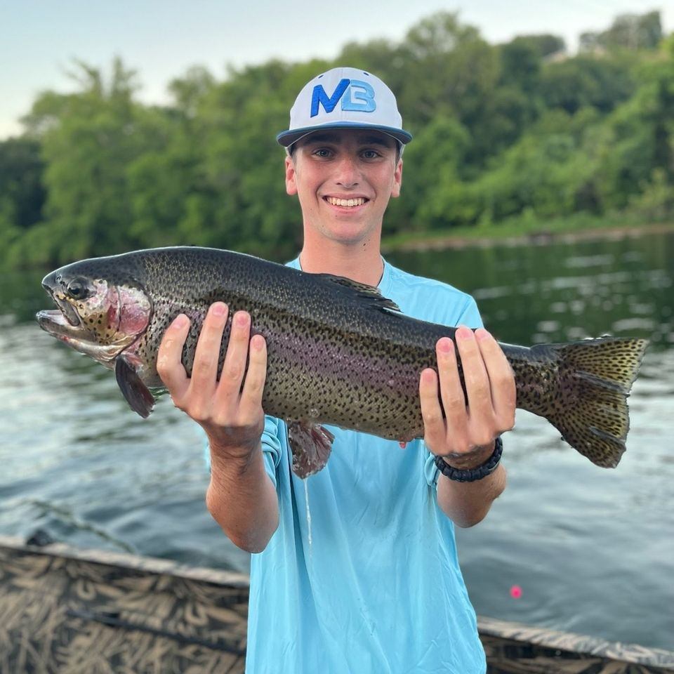 Angler with a rainbow trout in Branson