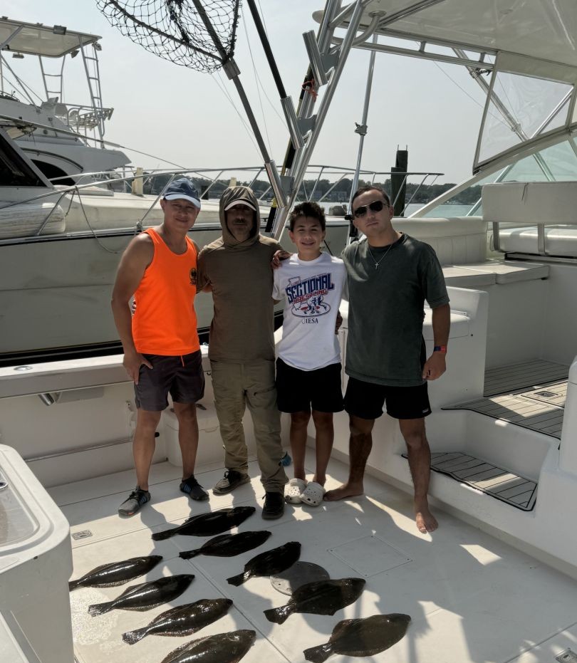 Successful fishing trip with fresh caught fish displayed on boat deck in Neptune City NJ