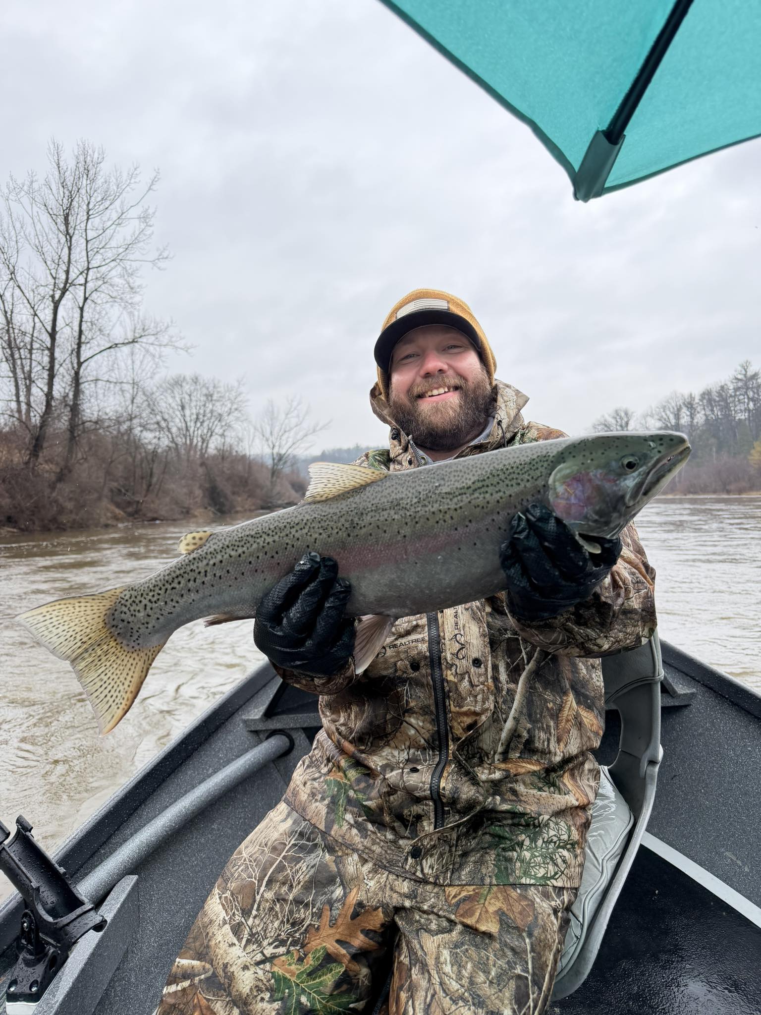 Rainbow trout caught while fishing in Brethren MI, displayed on boat