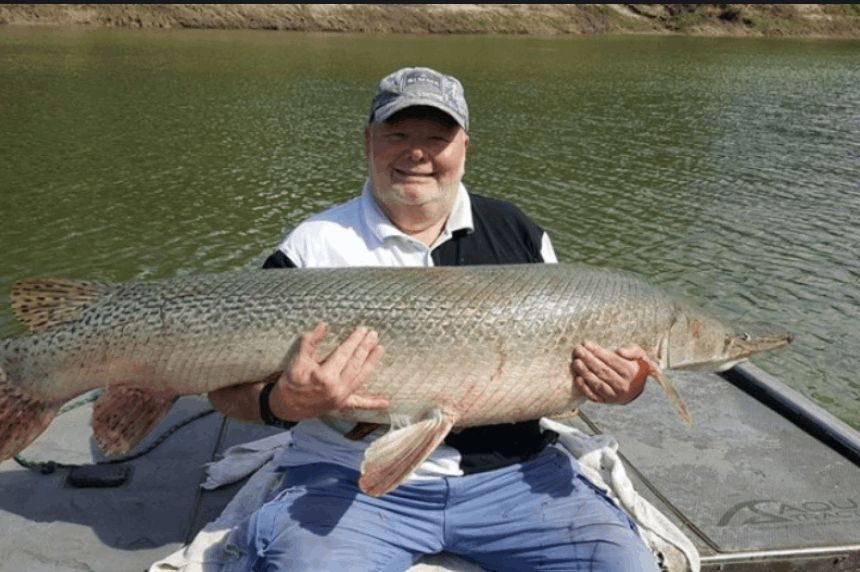 A single, large fish being reeled in from the Trinity river