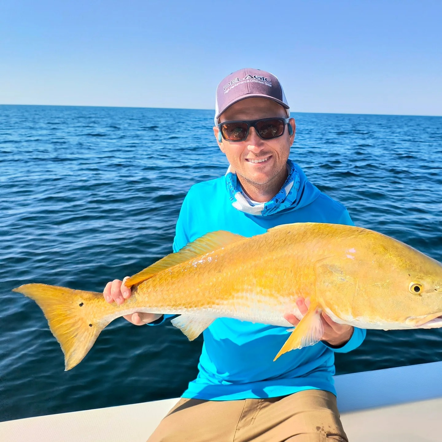 Fisherman holding a 27-inch catch in Gulf Breeze