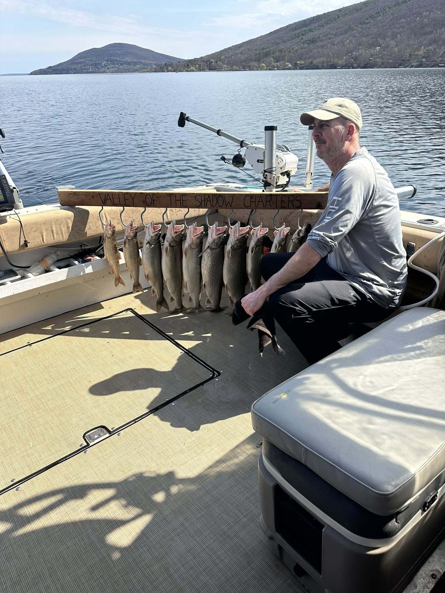 Successful fishing charter displaying catch of lake trout on boat deck in South Bristol NY