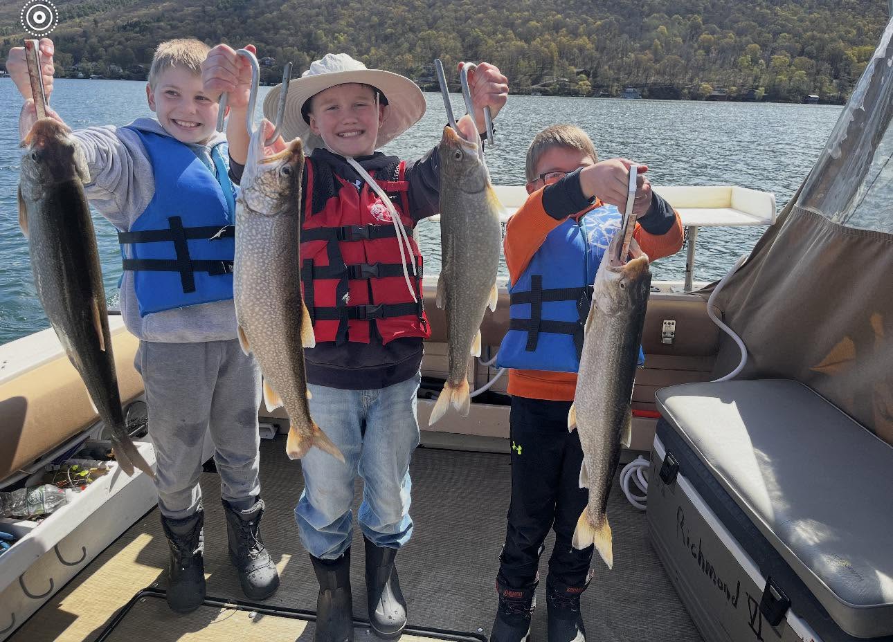 Lake trout fishing success on boat in South Bristol NY with multiple fish caught