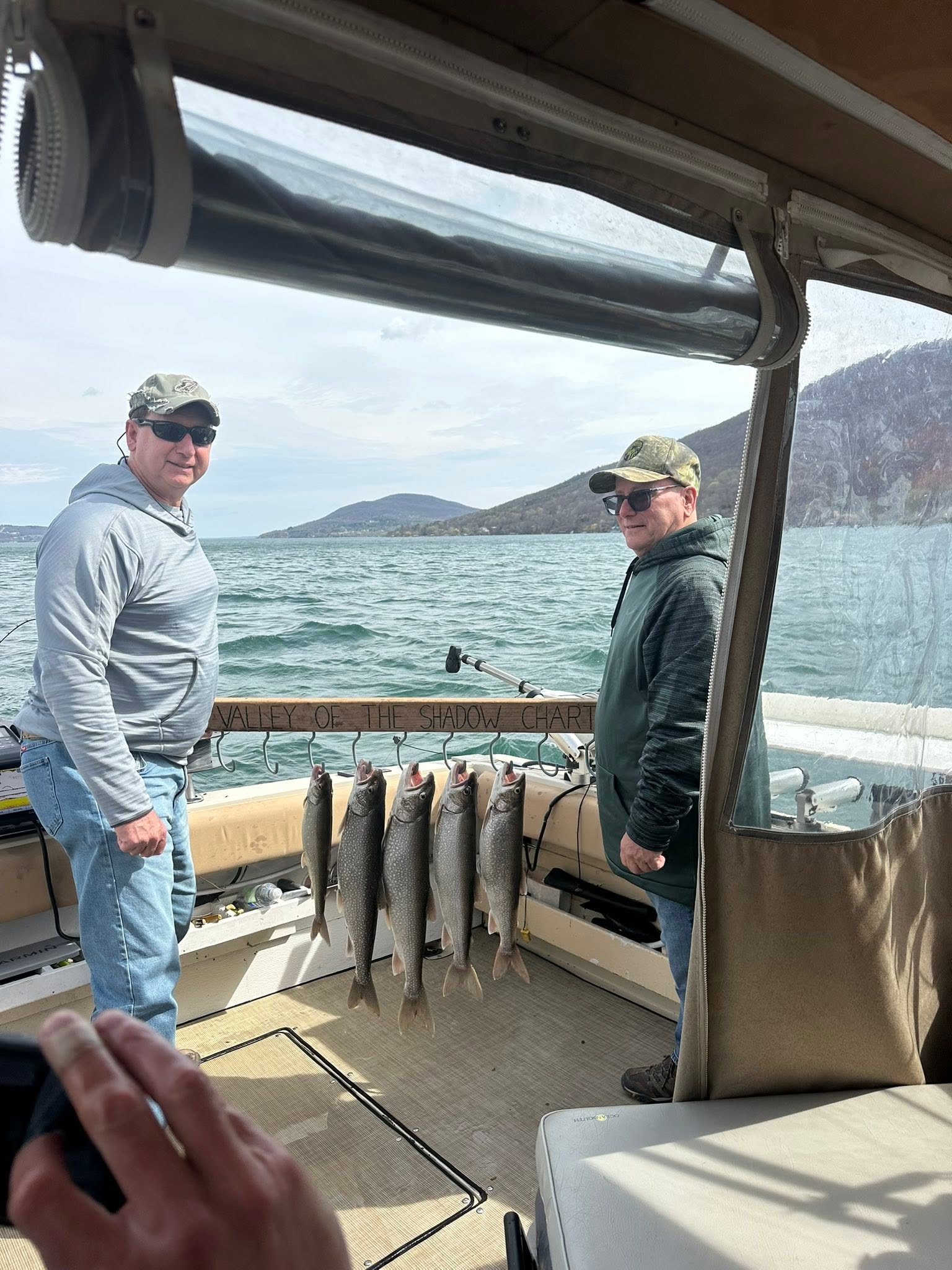 Lake trout fishing success on boat in South Bristol NY with multiple fish displayed