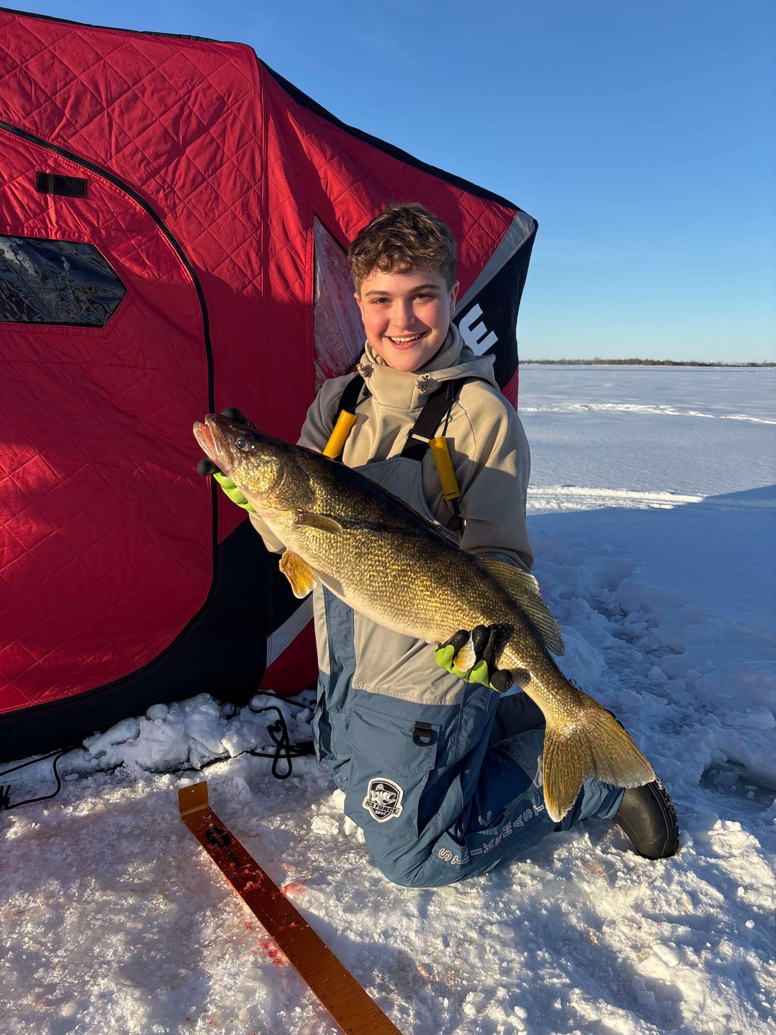 A fisherman holding a large fish in Ogdensburg