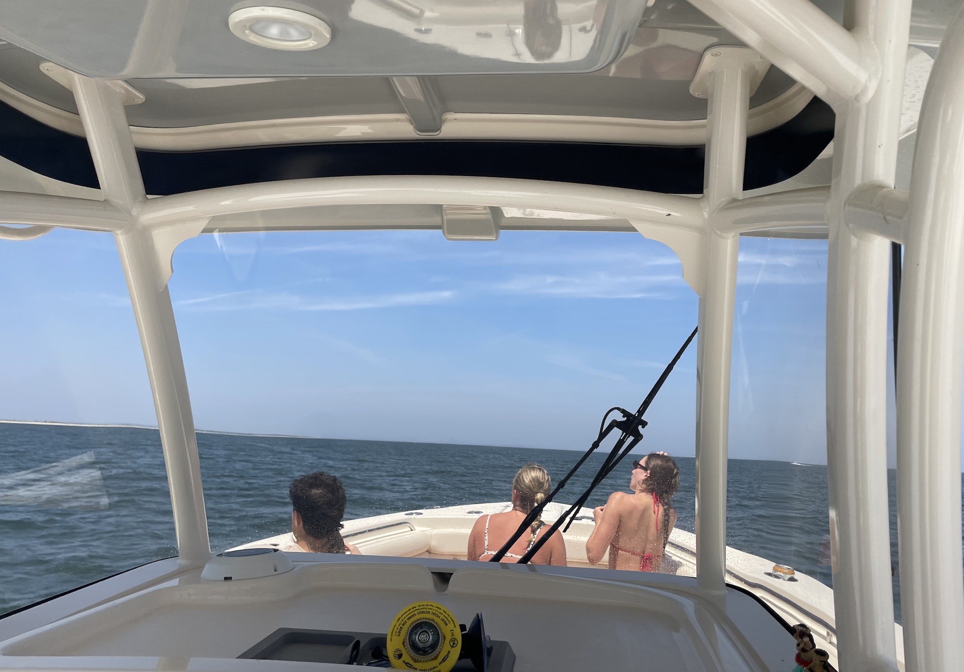 Fishing boat on ocean waters near Belmar NJ with T-top structure and fishing equipment