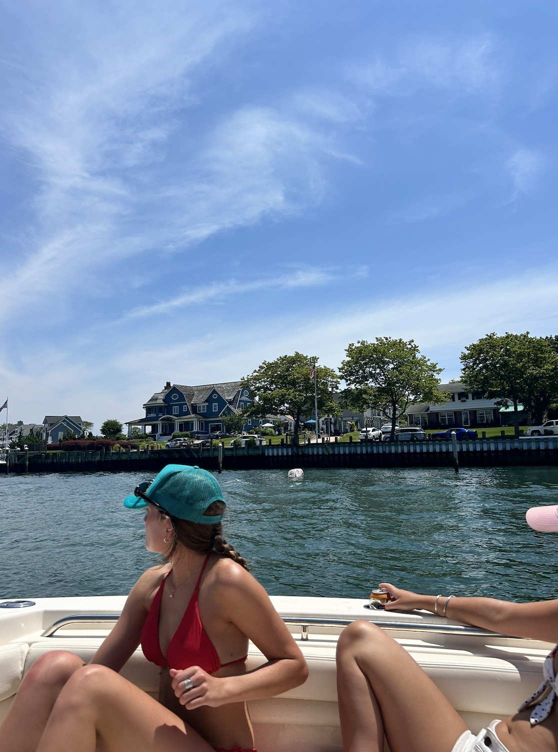 Boating cruise near waterfront homes in Belmar NJ with clear blue skies