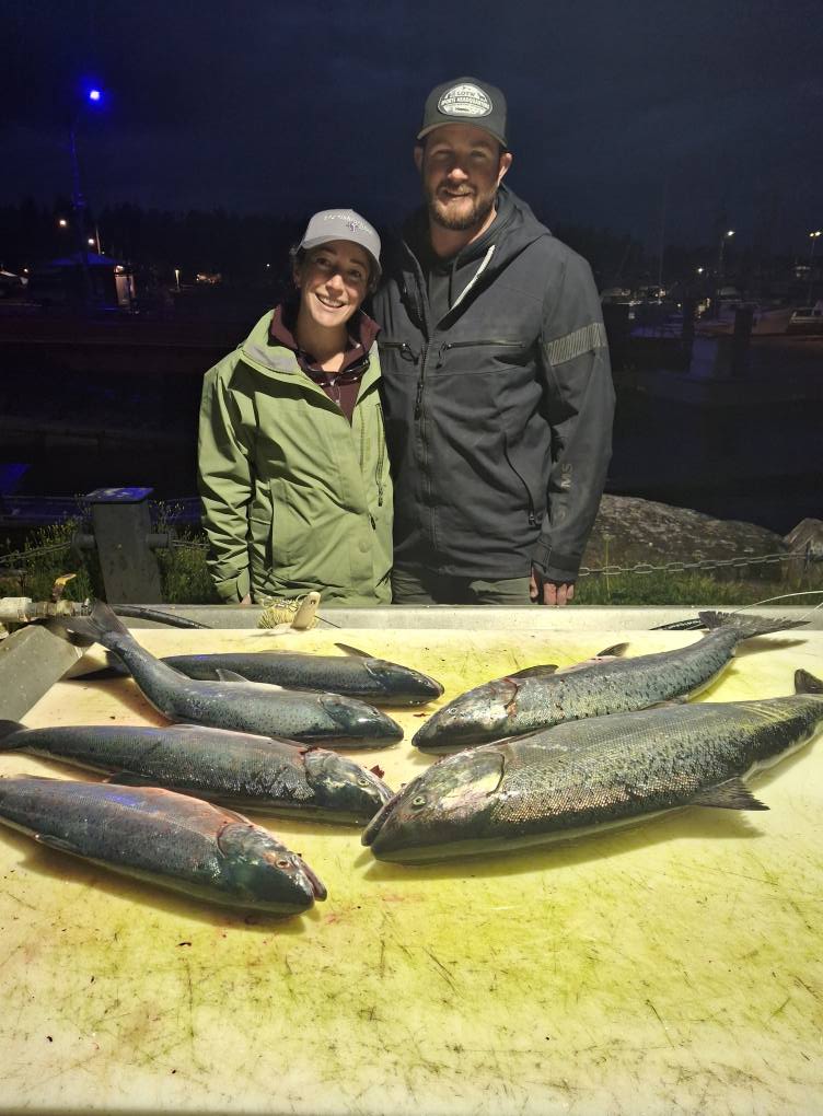 Fresh caught rainbow trout and coho salmon displayed on cleaning table in Nanaimo BC