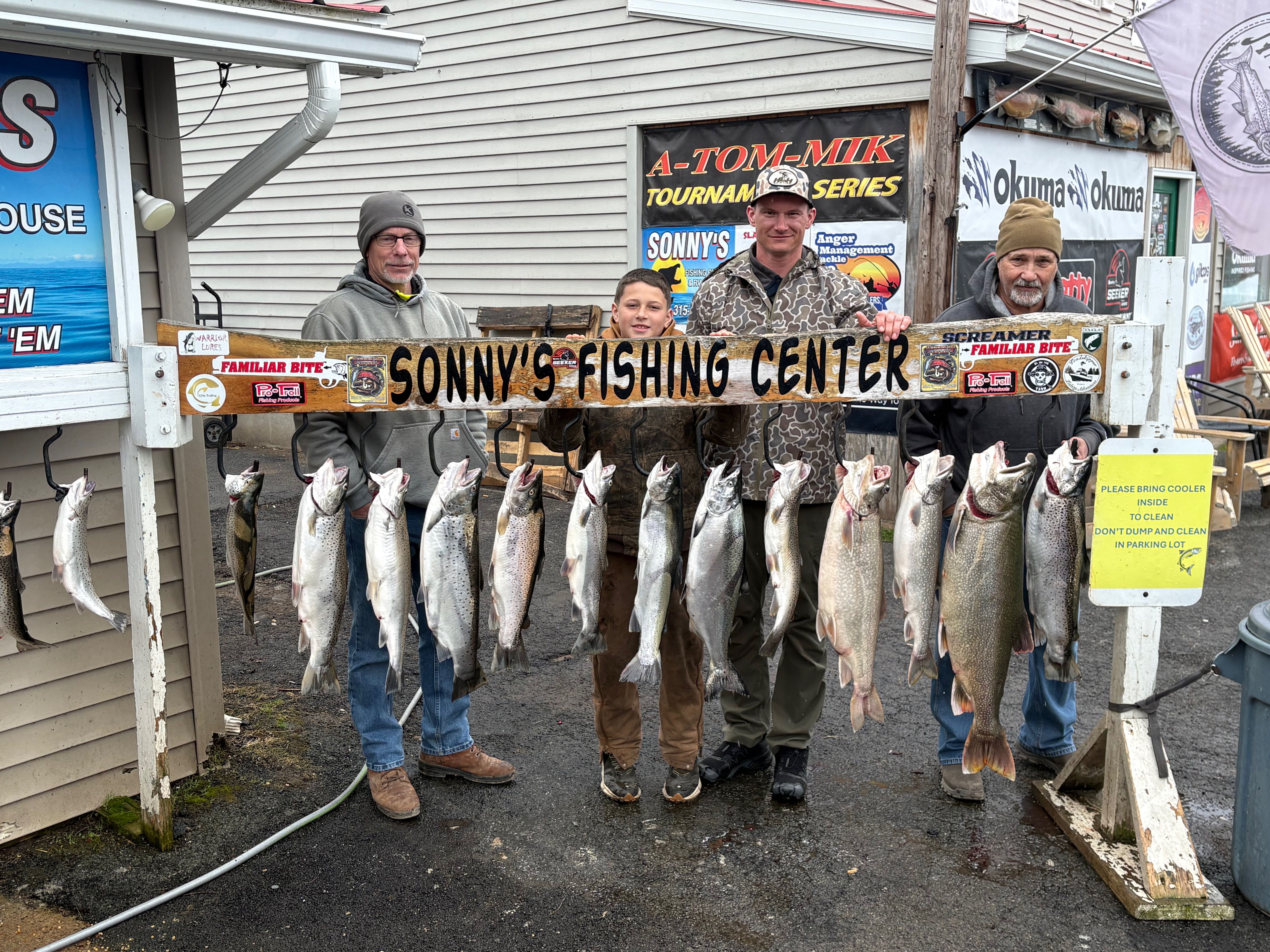 Successful fishing trip in Mexico NY displaying 14 fish including lake trout, rainbow trout, brown trout, chinook salmon, atlantic salmon, and coho salmon at Sonny's Fishing Center